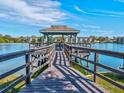 Wooden dock with gazebo overlooking a lake at 11485 Oakhurst Dr # 1100-312, Largo, FL 33774