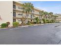 Condo building exterior with parking and landscaping at 11485 Oakhurst Dr # 1100-312, Largo, FL 33774