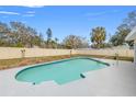 Inviting kidney shaped swimming pool in backyard at 1243 Bayshore Dr, Terra Ceia, FL 34250