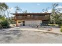 Two-story home with double garage and stone driveway at 13345 14Th St, Dade City, FL 33525