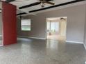 Spacious living room with brick fireplace and exposed beams at 1373 Fairfax Rd, Clearwater, FL 33764