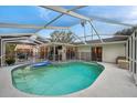 Relaxing kidney-shaped pool with screened enclosure at 1753 Lucas Dr, Clearwater, FL 33759