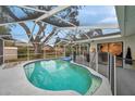 Refreshing kidney-shaped pool with screened enclosure at 1753 Lucas Dr, Clearwater, FL 33759