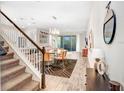 Elegant dining area with glass table, modern light fixture, and hardwood floors at 17806 Althea Blue Pl, Lutz, FL 33558