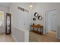 Bright and airy entryway with wood-look floors and decorative wall accents at 19145 Cherry Rose Cir, Lutz, FL 33558