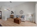 Cozy living room featuring a comfortable sofa and large clock at 19145 Cherry Rose Cir, Lutz, FL 33558