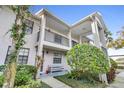 Two-story building with balconies and landscaping at 2188 Elm St # 1107, Dunedin, FL 34698