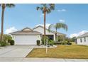 House exterior with landscaping and palm trees at 2234 Preservation Green Ct, Sun City Center, FL 33573