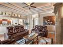 Spacious living room featuring leather recliners and a large artwork at 2262 Sagebloom Ter, North Port, FL 34286