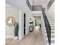 Bright and spacious entryway with hardwood floors and modern staircase at 2623 S Parkview St, Tampa, FL 33629