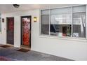 Condo entry with red door and hallway view at 2635 Seville Blvd # 109, Clearwater, FL 33764