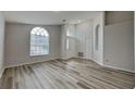 Bright and airy living room with wood-look flooring at 29325 Birds Eye Dr, Wesley Chapel, FL 33543