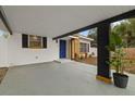 Modern carport with stylish black and white accents and lush greenery at 303 E 120Th Ave, Tampa, FL 33612