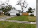 House exterior showcasing a two-car garage and fenced yard at 3202 Cullendale Dr, Tampa, FL 33618