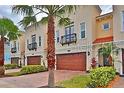 Three-story townhome building with a two-car garage and lush landscaping at 3222 W Empedrado St, Tampa, FL 33629