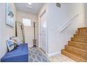 Bright entryway with built-in bench, coat rack, and staircase at 3405 W Swann Ave # 1, Tampa, FL 33609