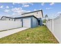 Two-car garage with a long driveway and white fence at 3469 17Th S Ave, St Petersburg, FL 33711