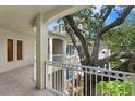 Spacious balcony overlooking lush landscaping and mature trees at 3507 Bayshore Blvd # 102, Tampa, FL 33629