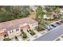 An aerial view showcasing a townhome, community pool, and parking at 4409 Winding River Way, Land O Lakes, FL 34639