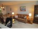 Living room with brown leather sofas and end tables at 4575 Cove Cir # 904, Madeira Beach, FL 33708