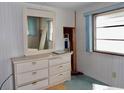 Bedroom with dresser, mirror, and carpeting at 5341 Mary St, Zephyrhills, FL 33542