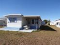 Side view of manufactured home with additional building at 5341 Mary St, Zephyrhills, FL 33542