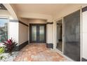 Front entry with double doors, tile flooring, and a glass-paned door at 5809 Cruiser Way, Tampa, FL 33615