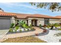 Stunning single-story home featuring lush landscaping, a brick walkway, and a tile roof in a desirable neighborhood at 5809 Cruiser Way, Tampa, FL 33615