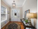 Bright entryway with hardwood floors, a chandelier, and a console table at 7418 S Morton St, Tampa, FL 33616