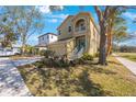 Two-story house with a two-car garage and nicely landscaped yard, tree-lined street at 7418 S Morton St, Tampa, FL 33616