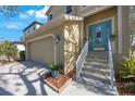 Two-story house with a two-car garage and nicely landscaped front entry at 7418 S Morton St, Tampa, FL 33616