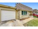 White garage door and light beige house exterior at 8330 Vendome N Blvd, Pinellas Park, FL 33781