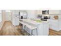 Modern kitchen with white cabinets, an island, and stainless steel appliances at 12011 Lansing Gln, Parrish, FL 34219