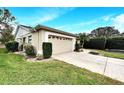 Well-maintained home exterior featuring a two-car garage and a neatly landscaped front yard at 13108 Dobree Pl, Riverview, FL 33579