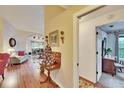 Comfortable living room featuring hardwood floors, neutral paint, and views into the dining area at 13108 Dobree Pl, Riverview, FL 33579