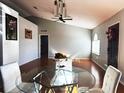 Bright dining room with glass table and hardwood floors at 1447 Coble Rd, Spring Hill, FL 34608