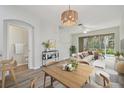 Bright dining room with light wood table and access to living room at 18924 Duquesne Dr, Tampa, FL 33647