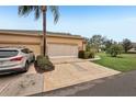 Attached garage with screen door and driveway at 2028 Acadia Greens Dr, Sun City Center, FL 33573