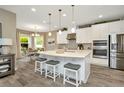 Modern kitchen with white cabinets, stainless steel appliances, and a large island at 29762 Chapel Chase Dr, Wesley Chapel, FL 33545