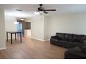 Open living area with hardwood floors, leather couch, and view into dining area at 317 Green Manor Dr # 38 B, Sun City Center, FL 33573
