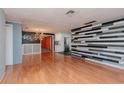 Bright living room with hardwood floors and modern wall decor at 3628 Holiday Lake Dr, Holiday, FL 34691
