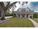 Two-story house with gray roof, white siding, and landscaped yard at 414 S Shore Crest Dr, Tampa, FL 33609
