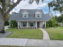 Two-story house with gray roof, white siding, and landscaped yard at 414 S Shore Crest Dr, Tampa, FL 33609