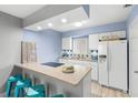 Updated kitchen with white cabinets, granite counters and tile backsplash at 4215 E Bay Dr # 1105C, Clearwater, FL 33764