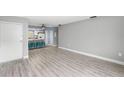 Bright living room with wood-look floors and open concept to kitchen at 4215 E Bay Dr # 1105C, Clearwater, FL 33764