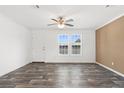 Spacious living room with wood-look flooring and a ceiling fan at 5234 Yellow Pine N St, St Petersburg, FL 33709