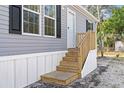 Wooden steps leading to the front entrance of the manufactured home at 5234 Yellow Pine N St, St Petersburg, FL 33709