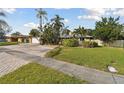 House with a large yard and brick driveway at 775 Rolling Hills Dr, Palm Harbor, FL 34683