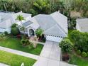 One-story house with a gray roof, landscaping, and driveway at 9625 Fox Hearst Rd, Tampa, FL 33647