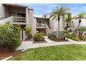 Condo building exterior with lush landscaping and walkway at 1111 N Bayshore Blvd # B7, Clearwater, FL 33759